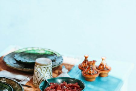 cooked meat on bowl and dishware on top table