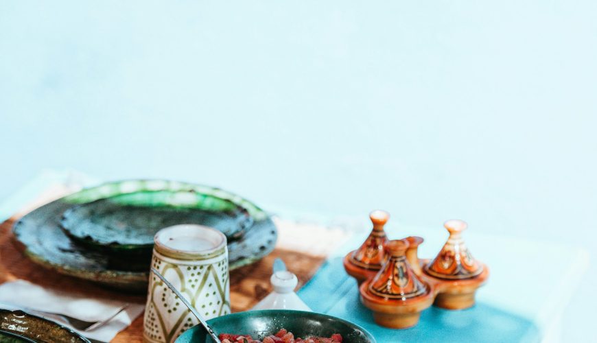 cooked meat on bowl and dishware on top table