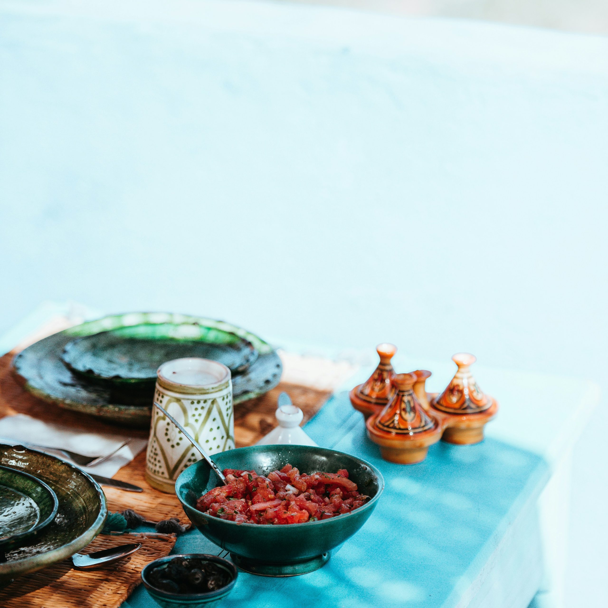 cooked meat on bowl and dishware on top table